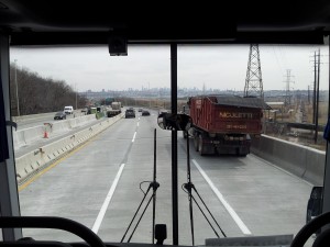 The Manhattan skyline appears in the windshield of a Vamoose bus.