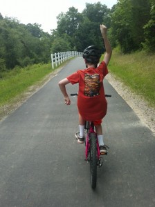 Travis hot-dogging on his red bike, June 2013.