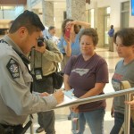 A deputy writes down contact info for couples hoping to wed